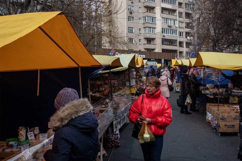 People shop at an outdoor market in Kiev amid tensions between Ukraine and Russia on February 11, 2022.