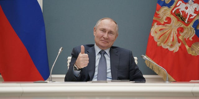 Russian President Vladimir Putin gives his thumbs up while attending a groundbreaking ceremony for the third reactor of the Akkuyu nuclear plant in Turkey, via video link in Moscow, Russia on March 10, 2021.