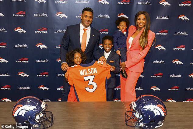 The legend: The soccer player, 33, is officially introduced as the Denver Broncos' newest quarterback as his proud wife, 36, daughter Sienna, four, son Wayne, one, and future stepson, seven watched