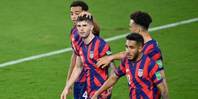 Christian Pulisic No. 10 of the United States celebrates scoring with his teammates during the FIFA World Cup Qualifier match between Panama and USMNT at Exploria Stadium on March 27, 2022 in Orlando, Florida.