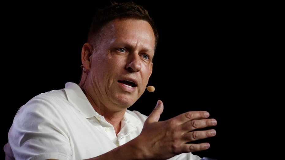 Peter Thiel, co-founder of PayPal, Palantir Technologies and Founders Fund, holds a 0 bond as he speaks during the Bitcoin 2022 conference at the Miami Beach Convention Center on April 7, 2022 in Miami, Florida.