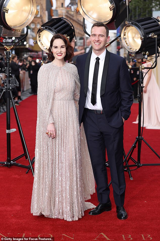 Gorgeous: The actress, who plays Mary Crowley on the series and its movie sequel, made sure all eyes were on her as she shimmered in a sexy dress, while posing next to her fiancé.