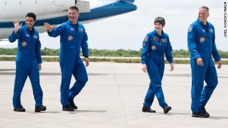 NASA astronauts Jessica Watkins, left, as Jill Lindgren, second from left, European Space Agency astronaut Samantha Cristoforetti, second from right, and NASA astronaut Robert Haines, right, as they leave NASA's launch and landing facility.  s Kennedy Space Center.