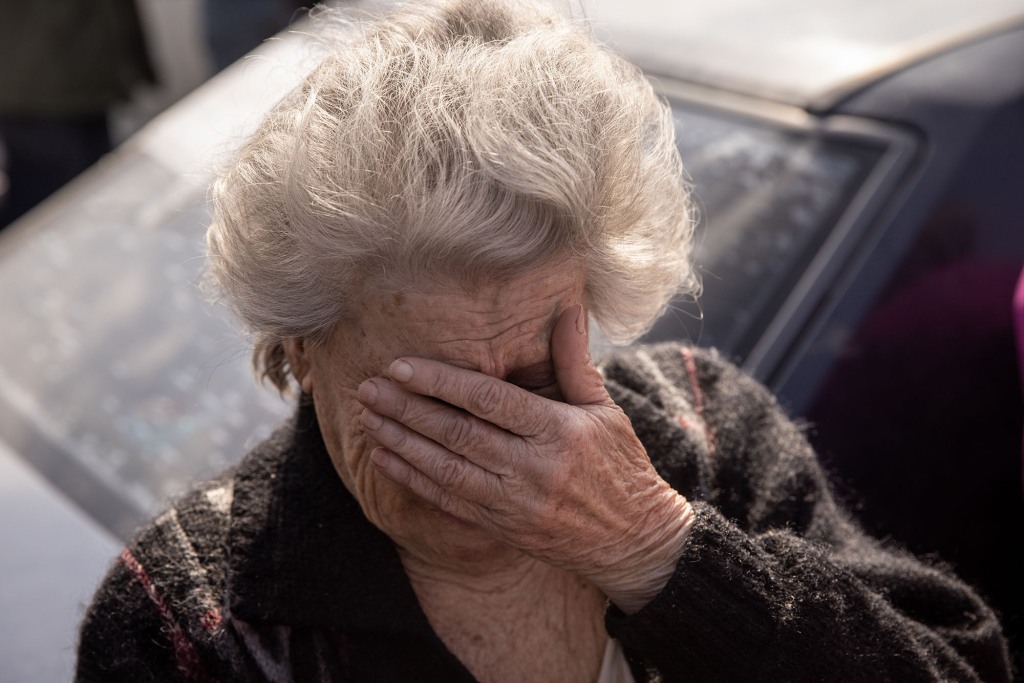 Dina, 81 from Mariupol, reacts after arriving by car at an evacuation point for people fleeing Mariupol, Melitopol and surrounding Russian-controlled cities on May 2, 2022 in Zaporizhia, Ukraine. 