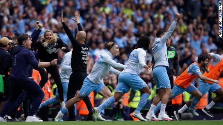 Guardiola and his team celebrate winning the English Premier League.