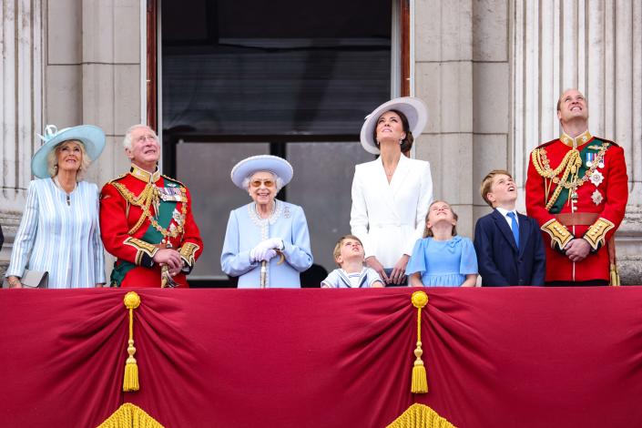 The royal family on the balcony of Buckingham Palace watching a Royal Air Force plane.