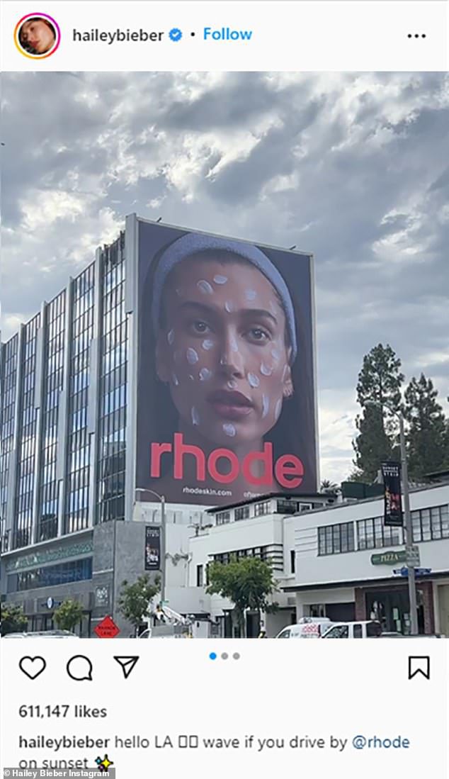 there she is!  Huge promotional poster affixed to the side of a tall building, showing a close-up of Hailey's face with Rhode's Barrier Restore cream dotted on her cheeks, forehead and chin