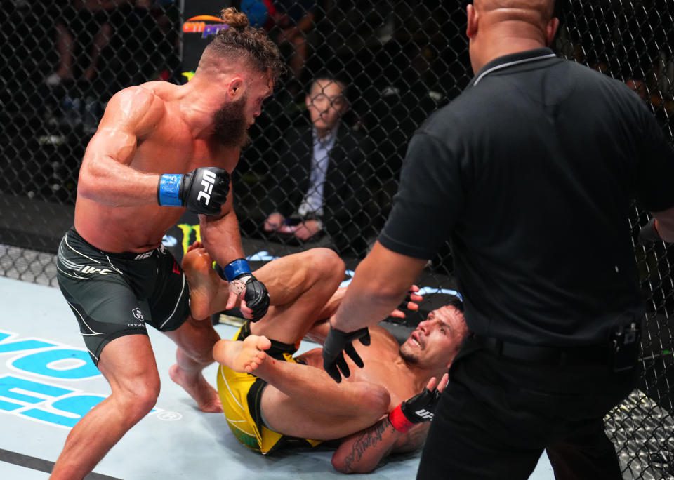 LAS VEGAS, NV - JULY 09: (LR) Rafael Viziev of Kazakhstan knocks out Brazil's Rafael dos Anjos in their light fight during the UFC Fight Night event at UFC APEX on July 09, 2022 in Las Vegas, Nevada.  (Photo by Chris Unger/Zova LLC.