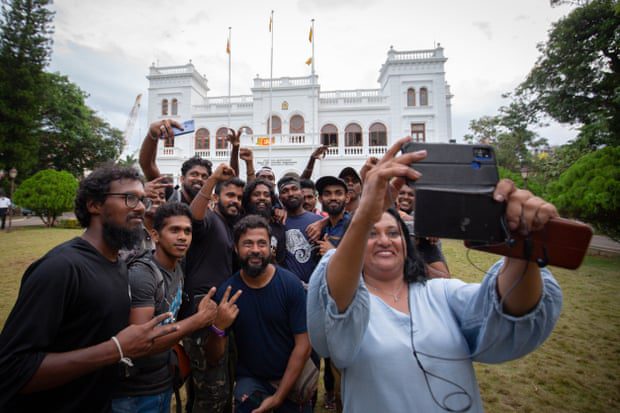 Protesters pose for a group selfie while returning the Prime Minister's Office to government authorities.