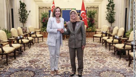 US House of Representatives Speaker Nancy Pelosi, left, and Singaporean President Halimah Yacoub shake hands at the Istana Presidential Palace in Singapore, Monday, August 1.