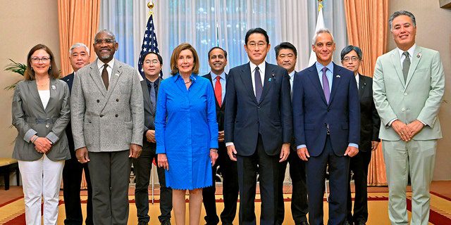 US House Speaker Nancy Pelosi, front, center left, and her congressional delegation pose for a photo with Japanese Prime Minister Fumio Kishida, center right, before a breakfast meeting at the Prime Minister's official residence in Tokyo.