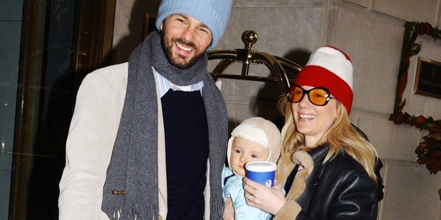 Actress Anne Heck, husband Colle Lavon, and baby Homer wait for a car at 59th Street and Fifth Avenue on December 13, 2002 in New York City.  