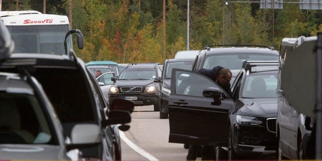 Cars queue to cross the border from Russia into Finland at the Valima border checkpoint in Ferrolahti in Ferrolahti, Finland, Friday, September 23, 2022. 