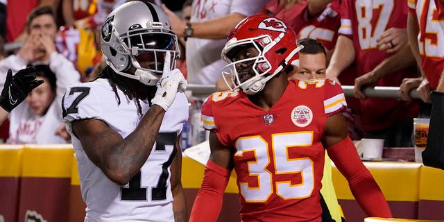 Davante Adams, No. 17, wide receiver for the Las Vegas Raiders, celebrates after scoring for Kansas City Chiefs Cornerback Jaylen Watson, No. 35, during the second half of an NFL football game on Monday, October 10, 2022, in Kansas City, Missouri.