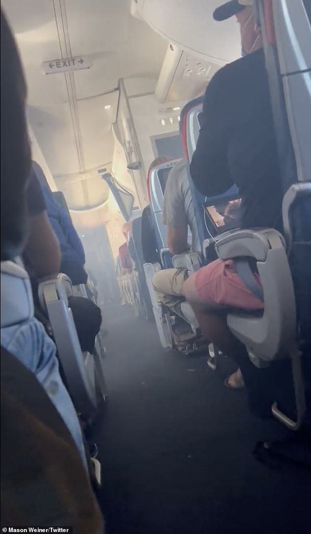 Passenger video shows the frightening scene as smoke trickles towards the rear of the plane, noticeably heavier towards the front as the alarm goes off.